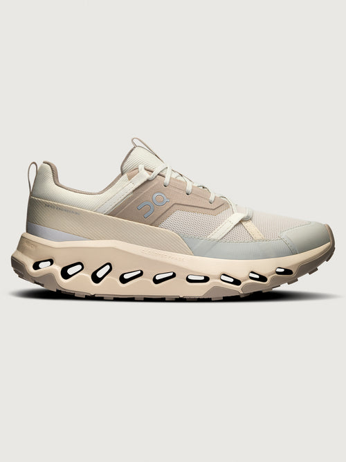 Beige sneaker with unique sole design on a light gray background