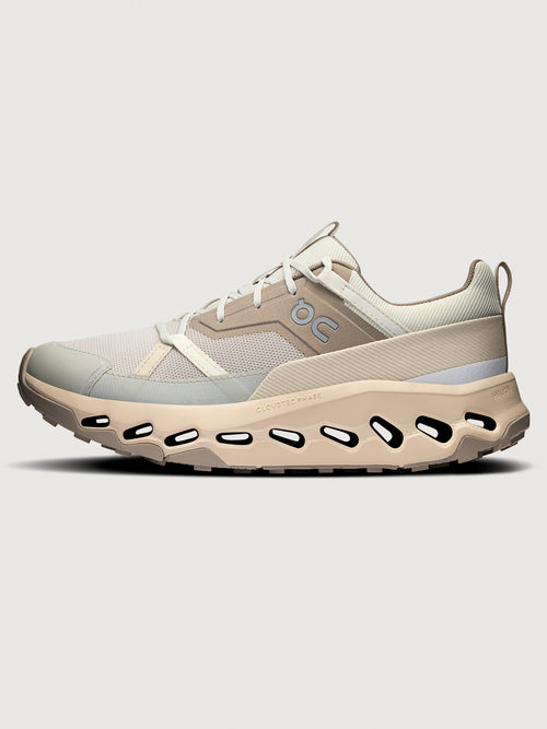 Beige and gray athletic shoe on a light gray background