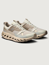Beige hiking shoes with mesh design on a light gray background