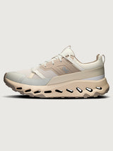 Beige sneaker with a white sole on a light gray background