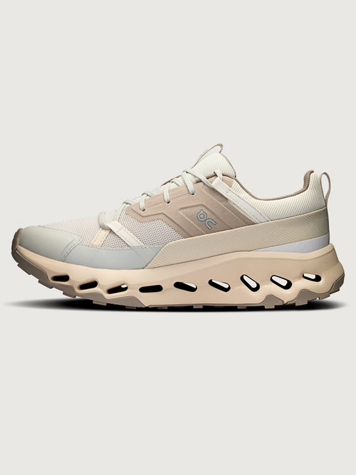 Beige sneaker with a white sole on a light gray background