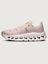 Pink running shoe with white sole on a light gray background