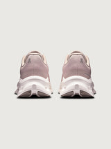 Pink running shoe with white sole on a light gray background