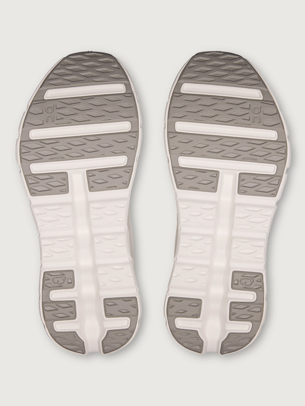 Pink running shoe with white sole on a light gray background