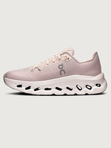 Pink running shoe with white sole on a light gray background