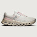 White and pink running shoe on a light gray background