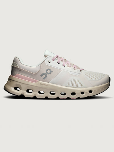 White and pink running shoe on a light gray background