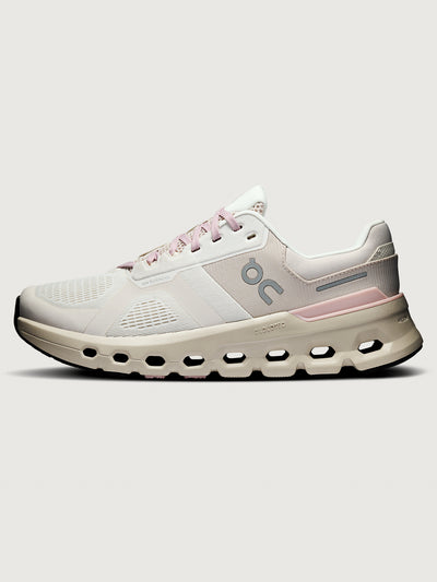 White and pink running shoe on a light gray background