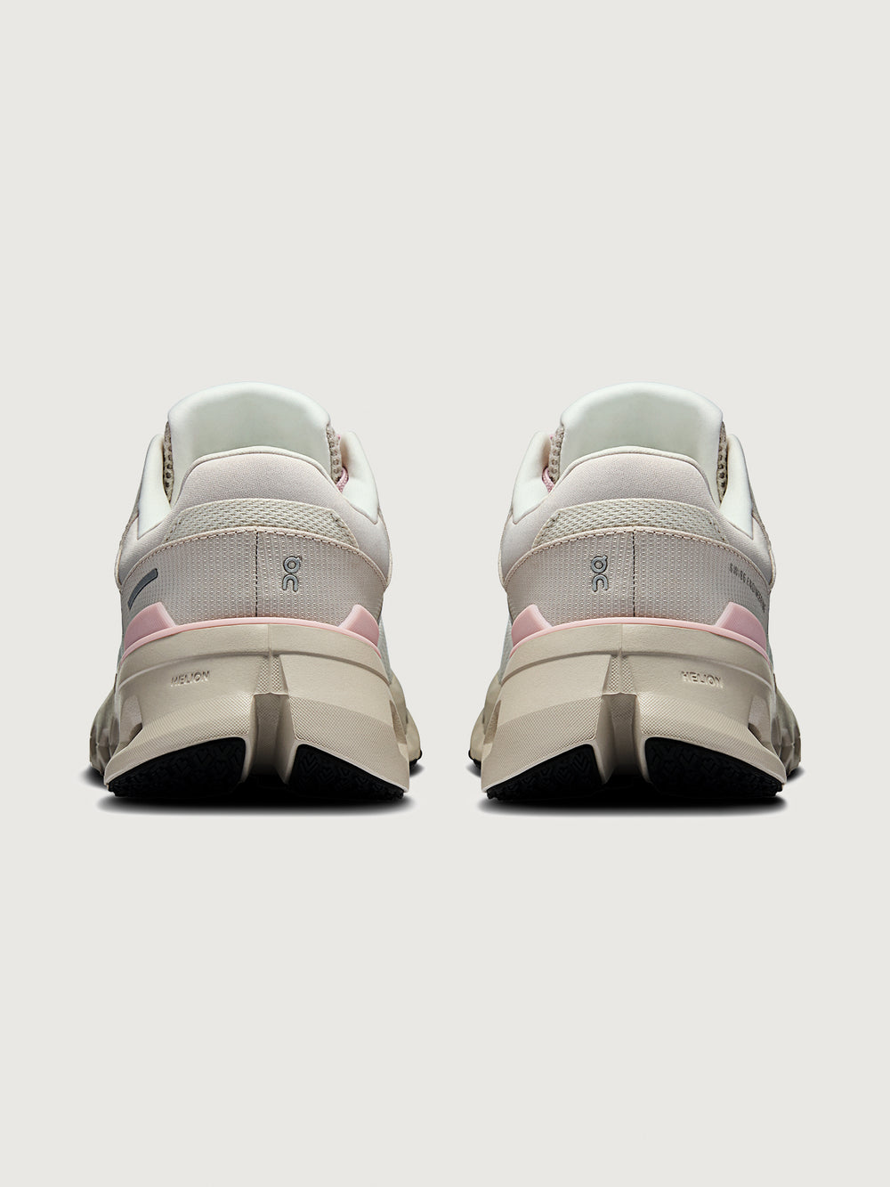 Pair of white and pink sneakers on a light gray background