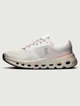 White and pink running shoe on a light gray background