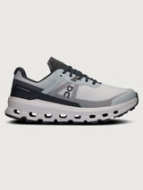 Gray and black running shoe on a light gray background