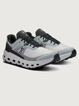 Gray and black running shoe on a light gray background