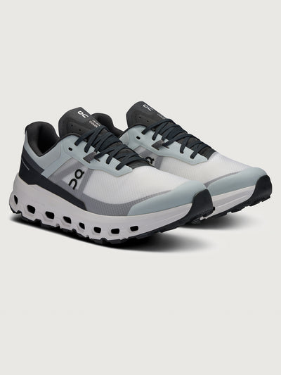 Gray and black running shoe on a light gray background