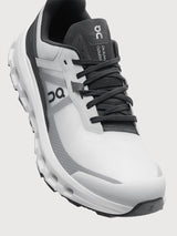 Gray and black running shoe on a light gray background