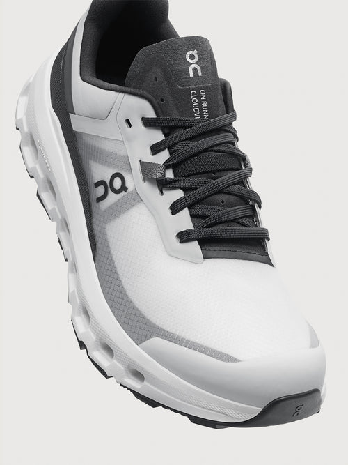 Gray and black running shoe on a light gray background