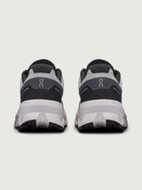 Gray and black running shoe on a light gray background