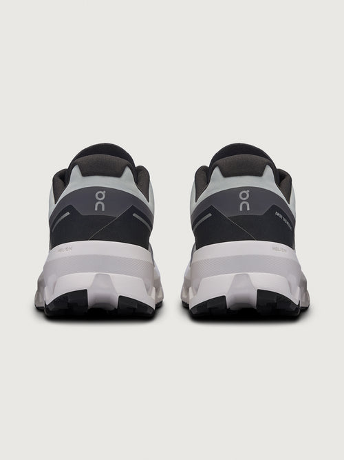 Gray and black running shoe on a light gray background