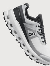 Gray and black running shoe on a light gray background