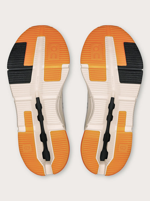 Truffle Dew-colored athletic sneakers.