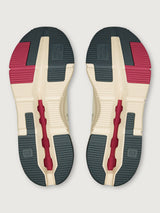 On Cloudnova 2 women’s sneakers in Ivory Grenadine, outsole view showing textured rubber tread in black, red, and ivory with Speedboard® support.