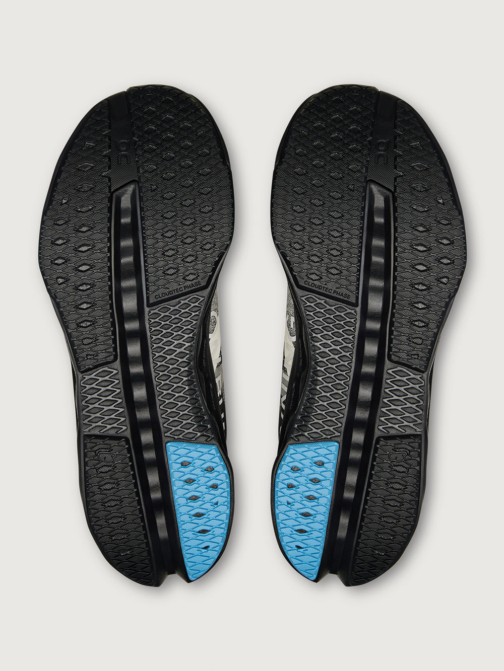 Black shoe insoles with blue accents on a light gray background