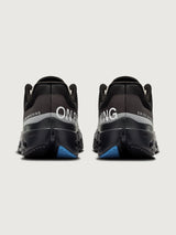 Black running shoes with blue sole on a light gray background