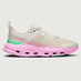 Sneaker with a pink sole and green accents on a white background