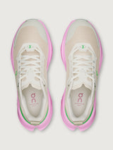 Pair of beige and pink running shoes on a white background