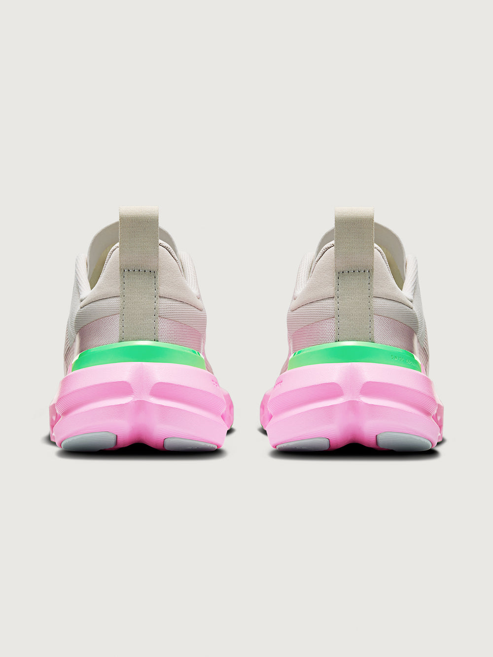 Pair of sneakers with pink soles and gray bodies on a white background