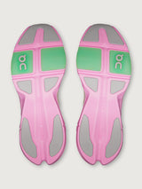 Pink and green athletic shoe sole with 'On' branding on a light gray background