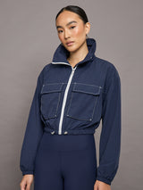 An Image of a Female Model is wearing Dark Navy Blue Zip-up Jacket