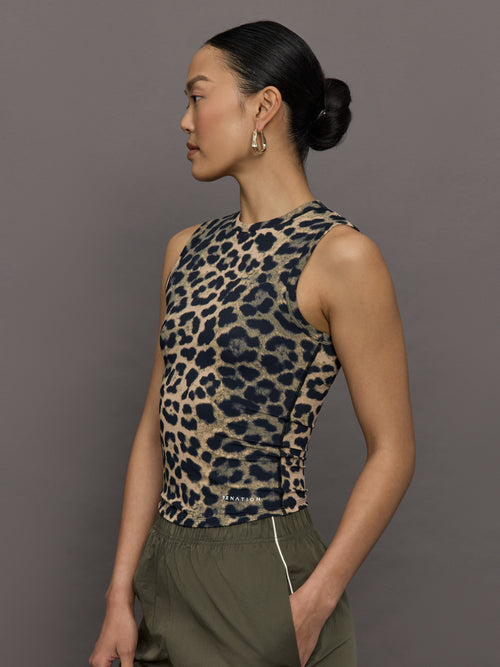 Model wears a full length leopard print patterned sleeveless muscle tank.