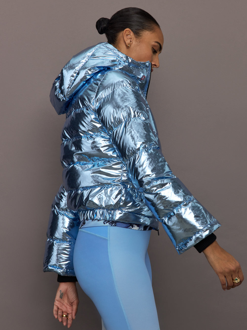 Side profile of Polar Flare Ski Jacket III Light Blue Foil showing metallic shine and hood.