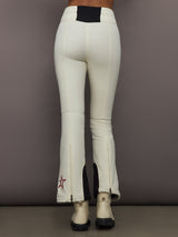 Back view of Aurora High Waist Ski Pant in Snow White with contrast black waistband and flared hem.