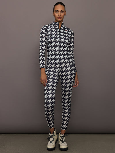 Full body view of model styled in 1/4 Zip Base Layer Top black and white houndstooth with matching leggings.