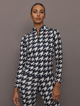 Front view of model wearing 1/4 Zip Base Layer Top in black and white houndstooth print.