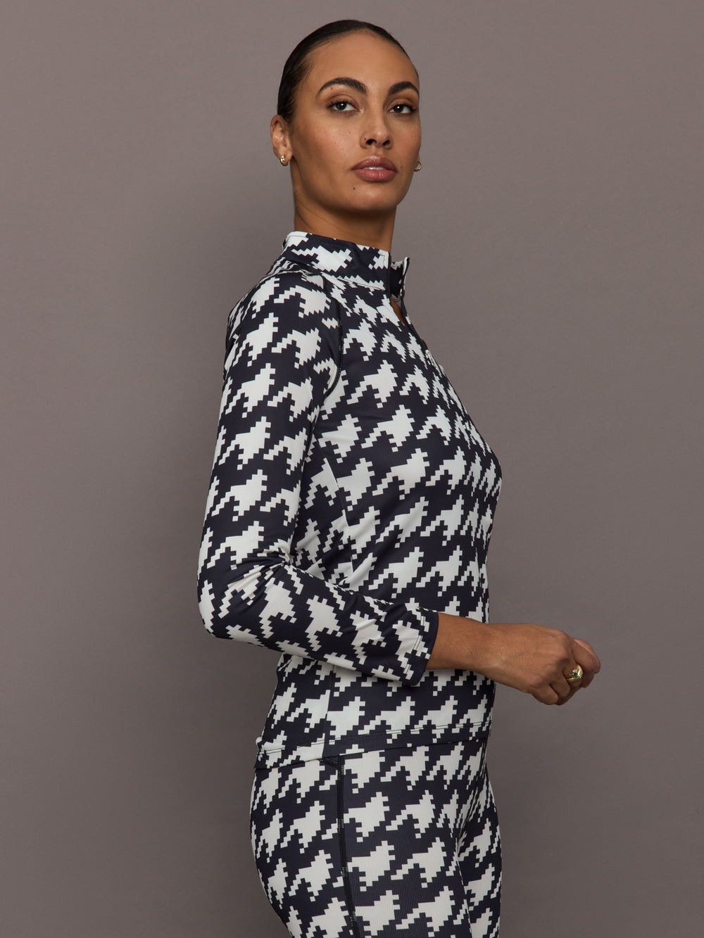 Side profile of 1/4 Zip Base Layer Top in black and white houndstooth print with long sleeves.
