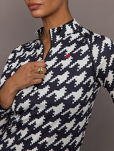 Close up of 1/4 Zip Base Layer Top in black and white houndstooth print showing zipper detail and Perfect Moment logo.