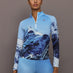Front view of model wearing 1/4 Zip Base Layer Top in Ski Lift Blue with mountain graphic print.