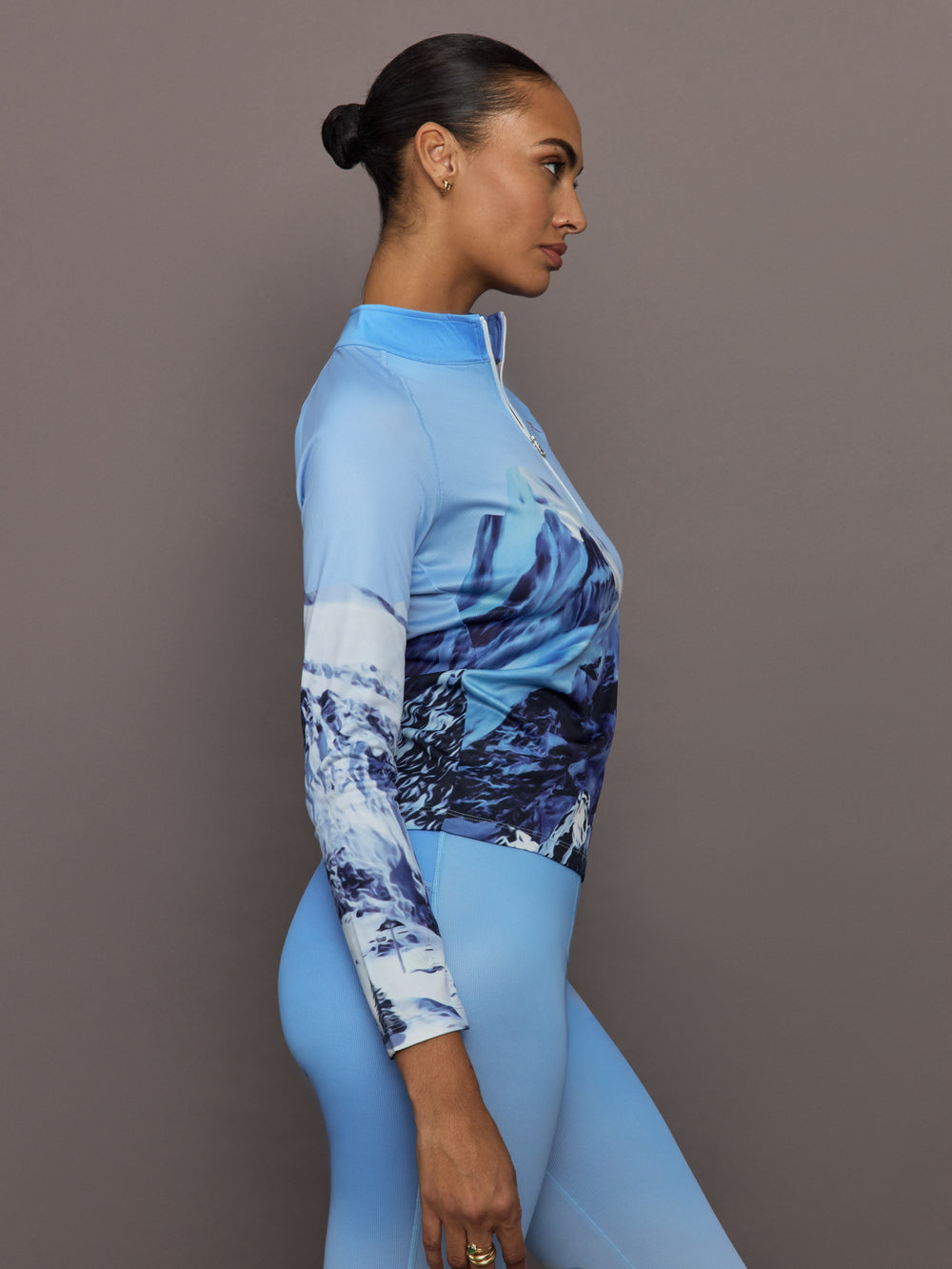 Side profile of 1/4 Zip Base Layer Top in Ski Lift Blue with long sleeves and slim fit.
