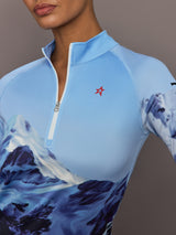 Close up of 1/4 Zip Base Layer Top in Ski Lift Blue featuring zipper collar and Perfect Moment logo detail.