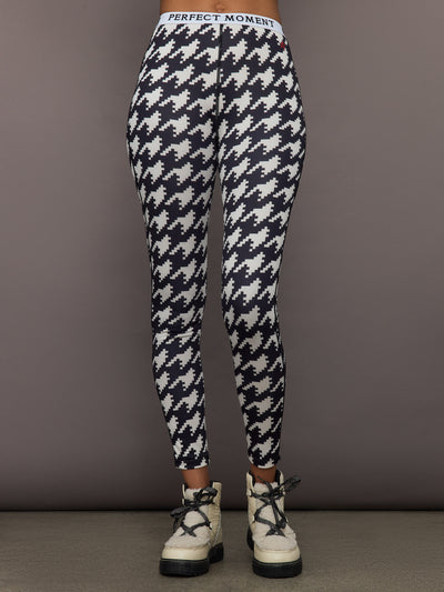 Front view of model wearing Printed Base Layer Leggings in black and white houndstooth print.