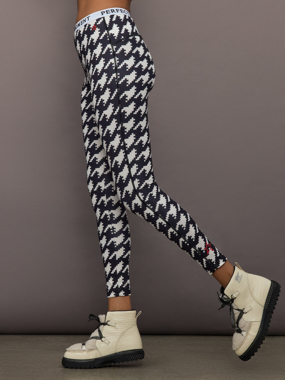 Side profile of Printed Base Layer Leggings in black and white houndstooth print with slim fit design.