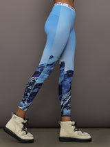 Side profile of Printed Base Layer Leggings in Ski Lift Blue showing mountain print detail.