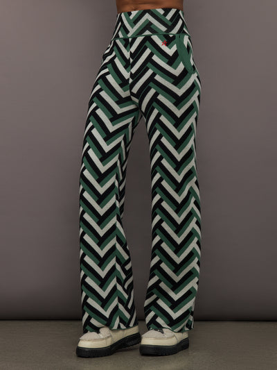 Front view of model wearing Chalet Merino Wool Knitted Pant in green waffle print.
