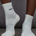 Model is wearing Dont Slip Grip Ankle Sock in White, front view.