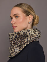 Woman wearing a leopard print scarf against a gray background