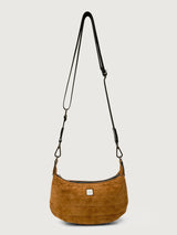 Brown shoulder bag with a black strap on a light gray background