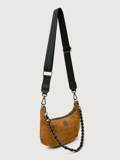 Brown shoulder bag with black strap and chain detail on a light gray background
