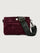 Burgundy suede handbag with a black seat belt strap 